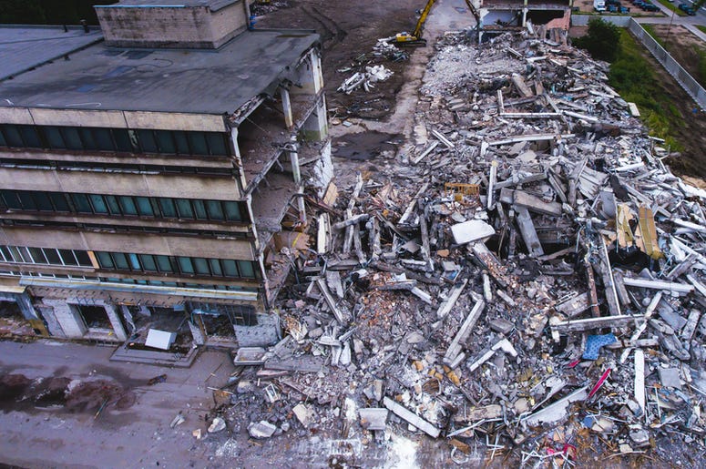 Al Menos 5 Muertos Y 13 Rescatados De Plaza Derrumbada En Monterrey A process of buliding demolition, demolished house, shot from air with drone. Earthquake, crusher.