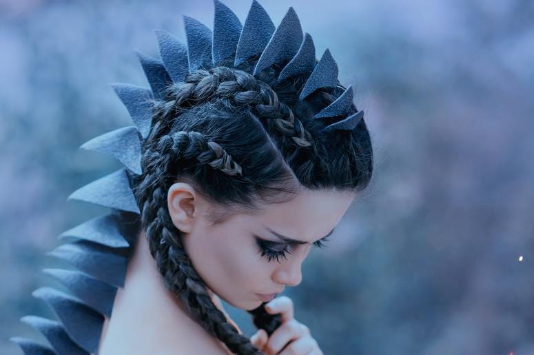 Stripper De Dallas Hace El Tubo-Tubo Disfrazada De Dinosaurio Dragon girl Black, sharp thorns cover the back and head of a young woman. Creative fabulous image of an alien humanoid creature. Unusual hairstyle with braids. Gothic dark makeup. Art retouching.