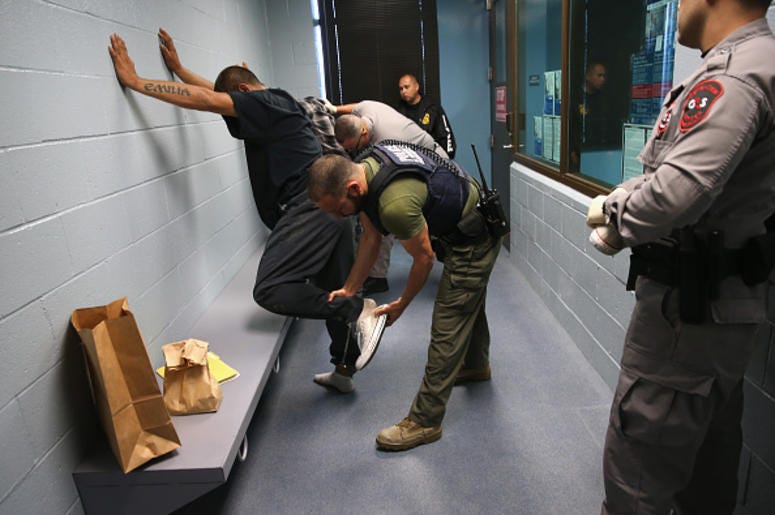 Redada De ICE Detiene 680 Migrantes En Mississippi U.S. Immigration and Customs Enforcement (ICE), agents frisk a detained immigrant at a processing center on October 14, 2015 in Camarillo, California. ICE builds deportation cases against thousands of both undocumented and Green Card holding immigrants co