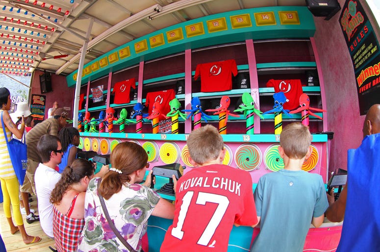 Kids play games at county fair. Kids play games at county fair.