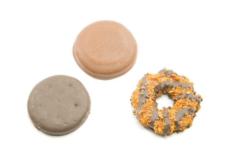 Three Delicious Cookies that include a chocolate peanut butter, coconut ring, and a thin chocolate mint cookie that are sold door to door. Three Delicious Cookies that include a chocolate peanut butter, coconut ring, and a thin chocolate mint cookie that are sold door to door.