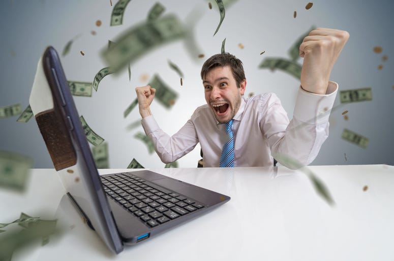 Young man wins a lottery online. Money are falling from above. Online betting concept. Young man wins a lottery online. Money are falling from above. Online betting concept.