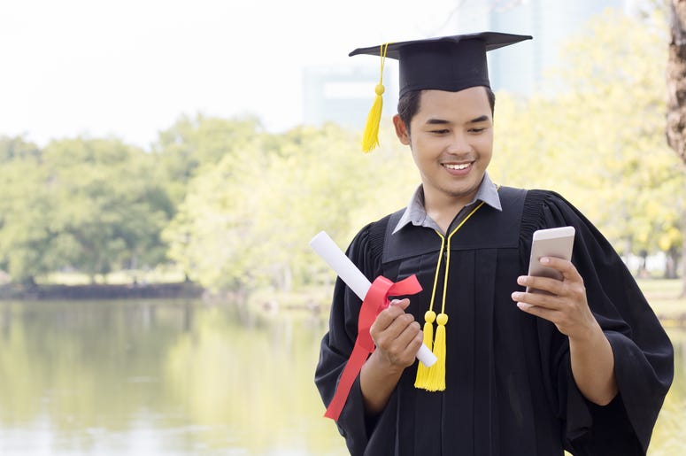 graduate holding phone graduate holding phone
