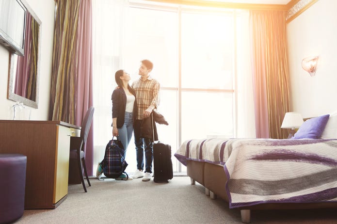 Young happy couple arrived to hotel room on honeymoon Young happy couple arrived to hotel room on honeymoon