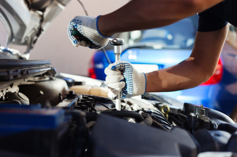 Mechanic working in auto repair garage Mechanic working in auto repair garage