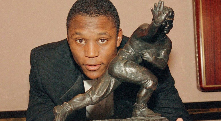 Oklahoma State's running back Barry Sanders poses with his Heisman Trophy at New York's Marriott Marquis Hotel.