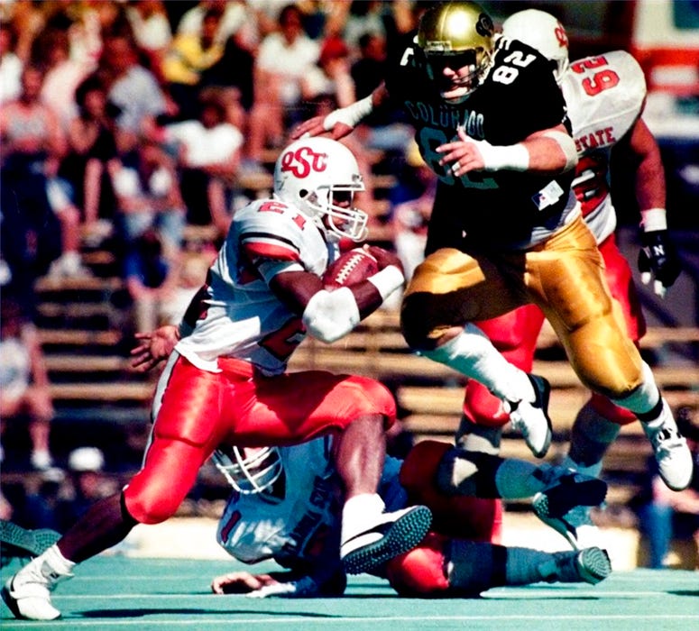 Oklahoma State runner Barry Sanders (21) runs past Colorado defender Cole Hayes during the second quarter of a college football game.