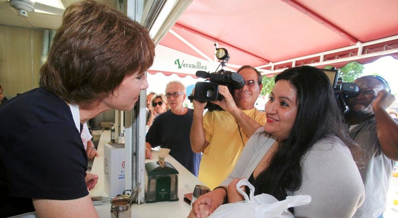 Florida Gubernatorial candidate Gwen Graham, left, interacts with Georgina Morgan during a visit to Versailles Restaurant on Tuesday