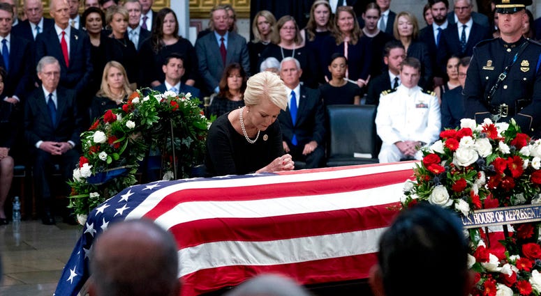 Cindy McCain, wife of, Sen. John McCain, R-Ariz., pauses at her husband's casket as he lies in state in the Rotunda of the U.S. Capitol