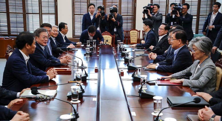 South Korean President Moon Jae-in, second from left, presides over a meeting with his security ministers, including National Security Advisor Chung Eui-yong, second from right, and National Intelligence Service Director Suh Hoon, third from right