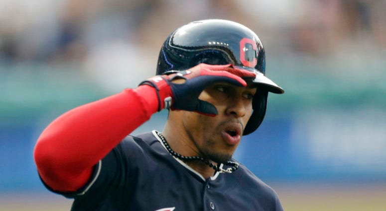 Cleveland Indians' Francisco Lindor salutes as he runs the bases after hitting a solo home run