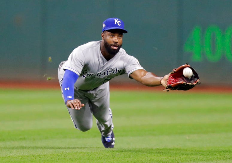 Kansas City Royals' Brian Goodwin dives for the ball hit by Cleveland Indians' Brandon Guyer