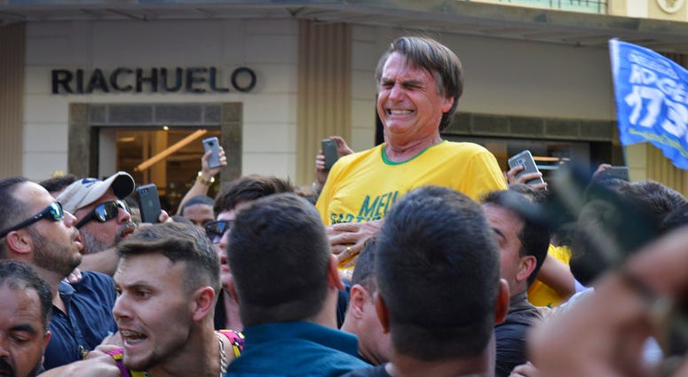 Jair Bolsonaro grimaces right after being stabbed in the stomach during a campaign rally in Juiz de Fora, Brazil,
