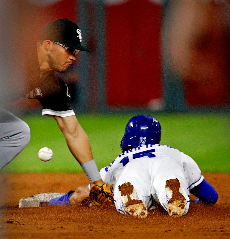 Kansas City Royals' Whit Merrifield (15) beats the stag by Chicago White Sox third baseman Yolmer Sanchez to steal second during the third inning