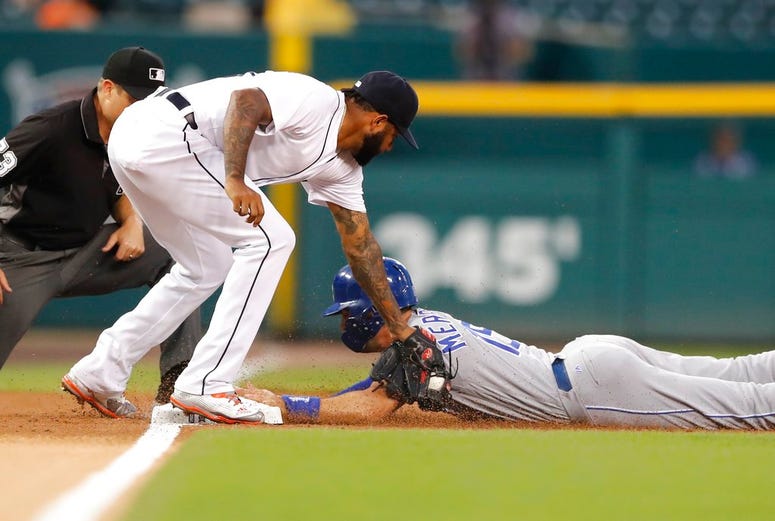 Kansas City Royals' Whit Merrifield beats the tag of Detroit Tigers third baseman Ronny Rodriguez and steals third during the first inning