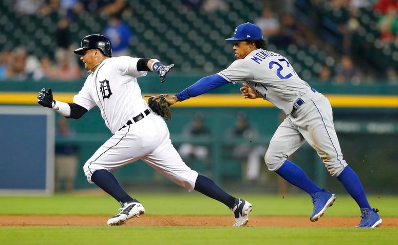 Detroit Tigers' Victor Martinez, left, is caught in a rundown by Kansas City Royals second baseman Adalberto Mondesi during the first inning