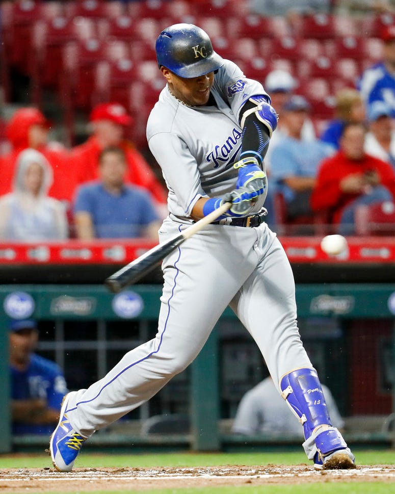 Kansas City Royals' Salvador Perez hits a single off Cincinnati Reds starting pitcher Matt Harvey during the second inning o