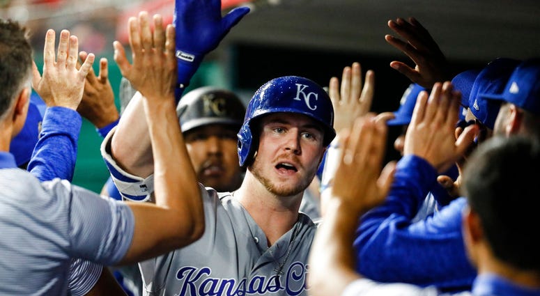 Kansas City Royals' Ryan O'Hearn celebrates in the dugout after hitting a two-run home run off Cincinnati Reds starting pitcher Matt Harvey