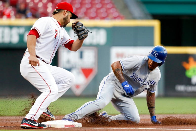 Kansas City Royals' Adalberto Mondesi, right, steals third against Cincinnati Reds third baseman Eugenio Suarez (7) during the first inning of