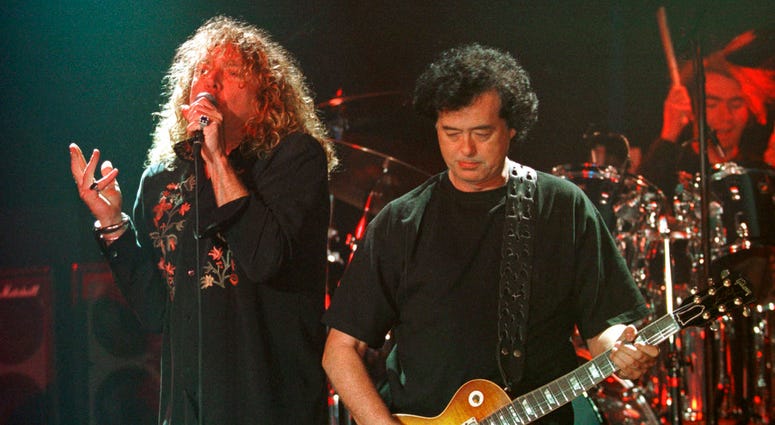 Led Zeppelin's Robert Plant, left, performs with guitarist Jimmy Page