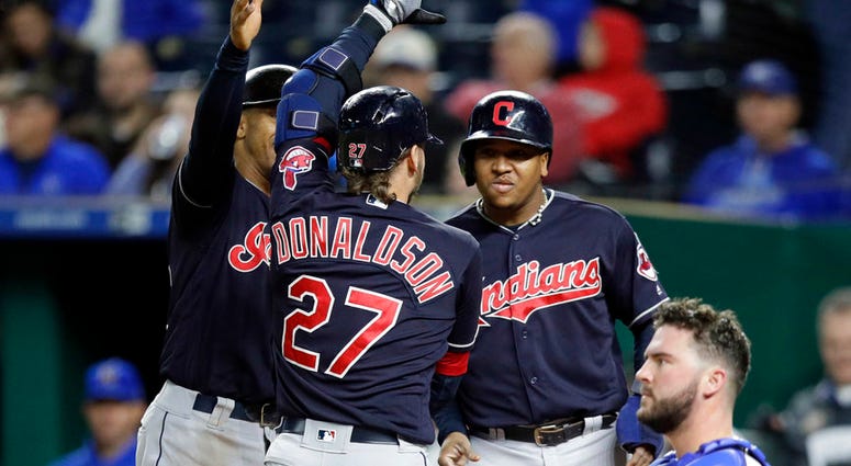 Cleveland Indians' Josh Donaldson (27) celebrates his grand slam with teammates Michael Brantley, left, and Jose Ramirez during the seventh inning