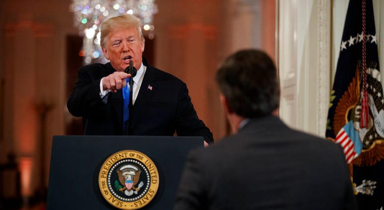 President Donald Trump speaks to CNN journalist Jim Acosta during a news conference in the East Room of the White House