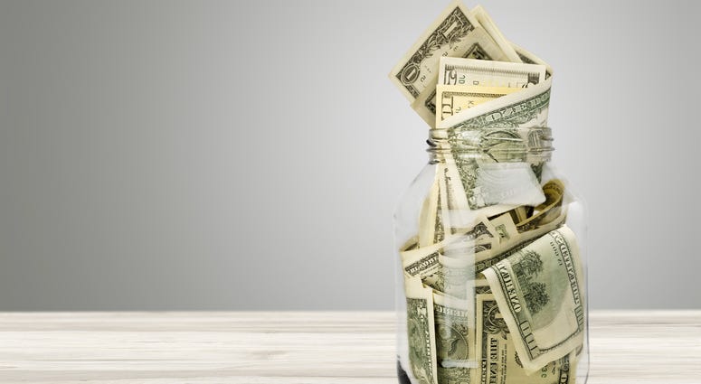 Glass jar for money on background