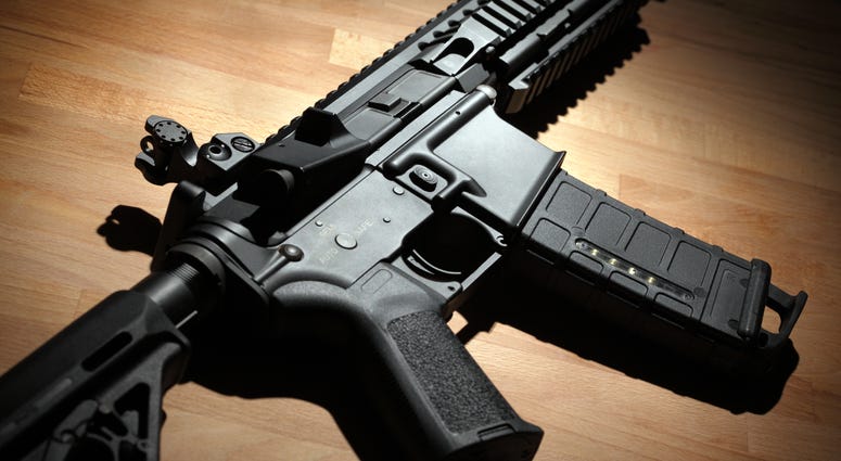 Modern custom AR-15 carbine on a wooden surface