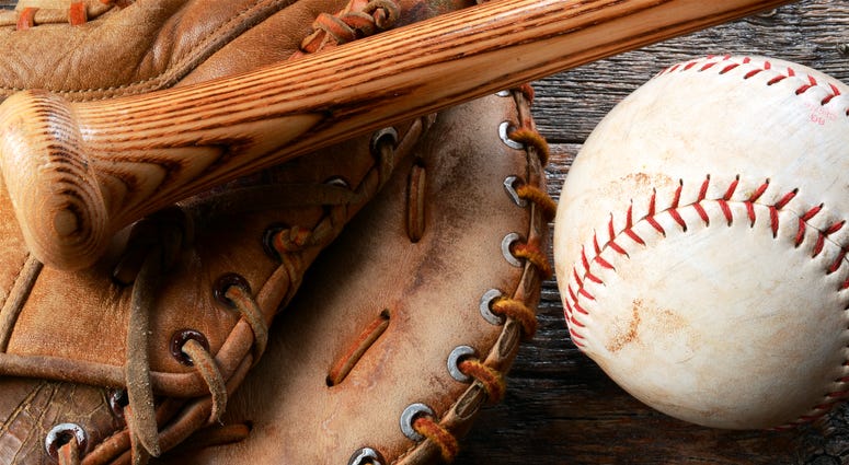 A top view image of an old used baseball, baseball glove, and baseball bat