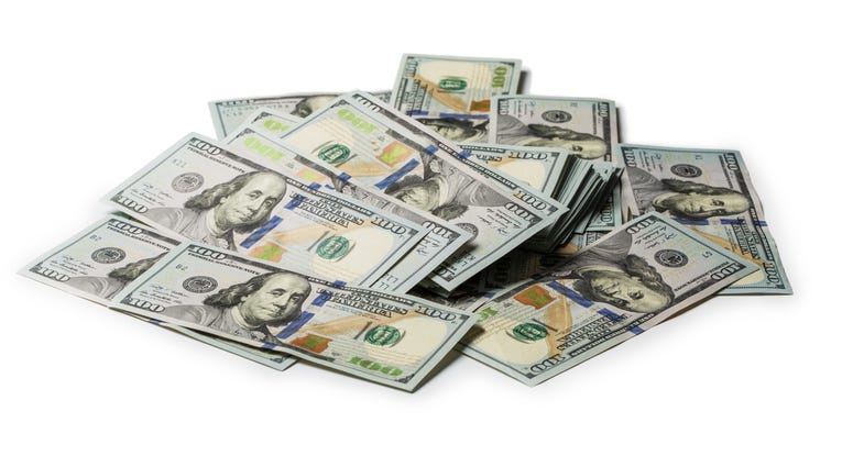 Bundle of US 100 dollars bank notes isolated on white background