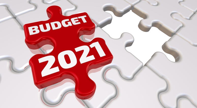 Folded white puzzle elements and one red with text BUDGET 2021