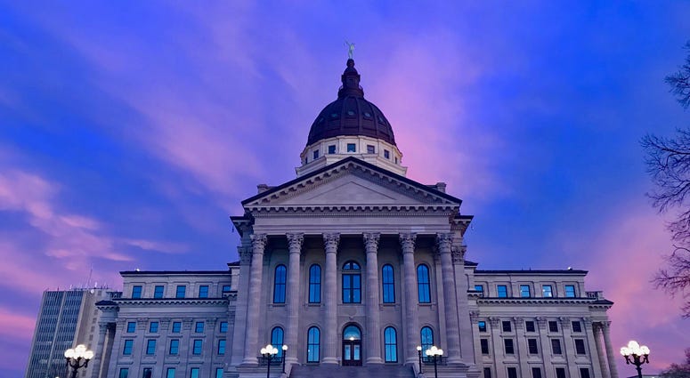Kansas State Capitol building during a colorful sunset