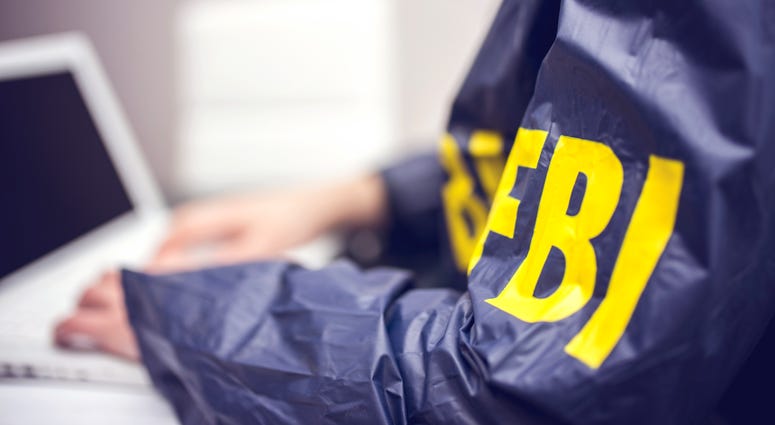 FBI agent working on a computer in an office