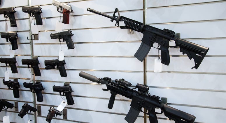 Gun wall rack with rifles and pistols