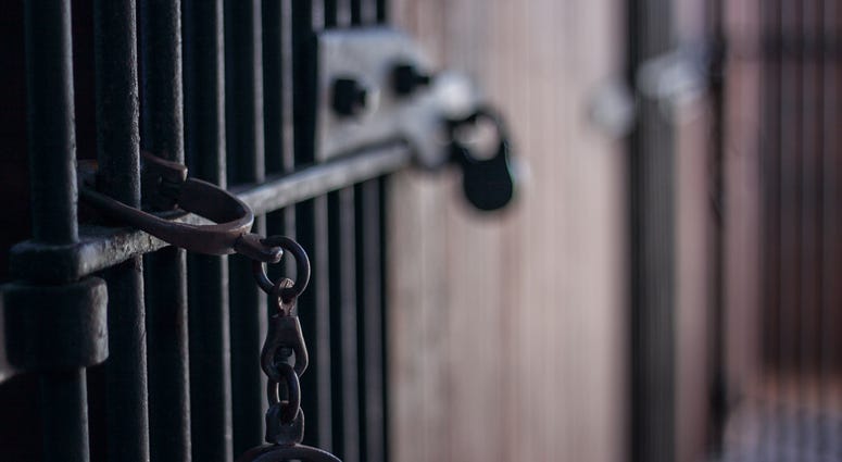 Handcuffs in abandoned jail with bars