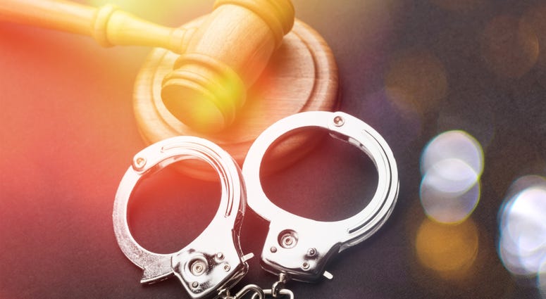 High angle view of gavel and handcuffs