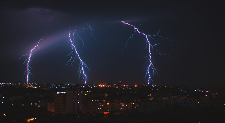 Photo of lightning over big city