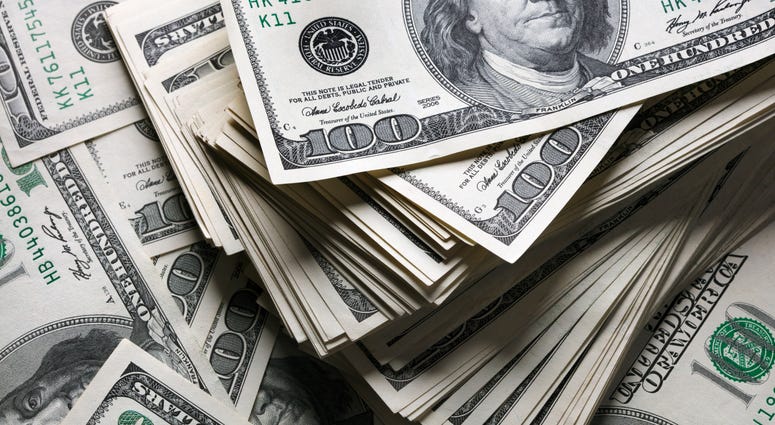 stack of one hundred dollars notes on dollars background