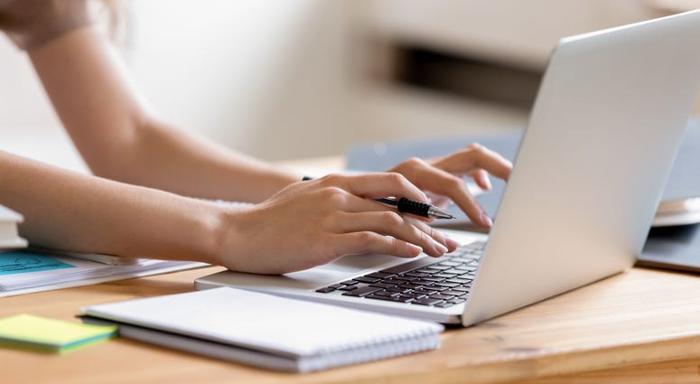 Closeup cropped image woman typing using laptop