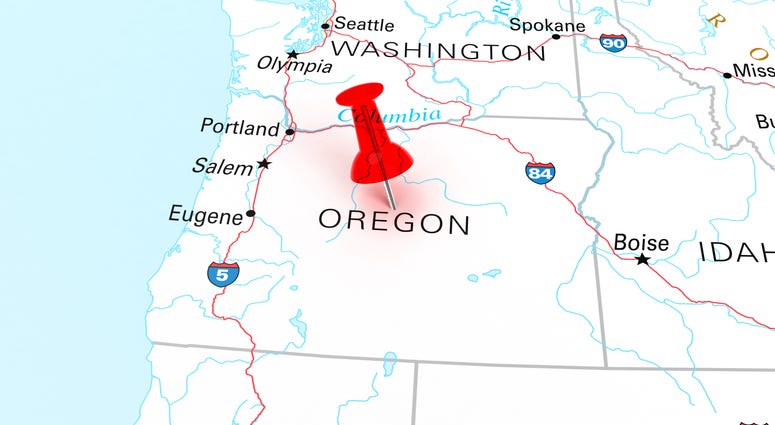 Red thumbtack over Oregon state USA map