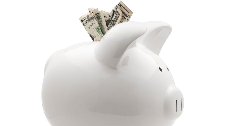 White piggy bank with money isolated on white background