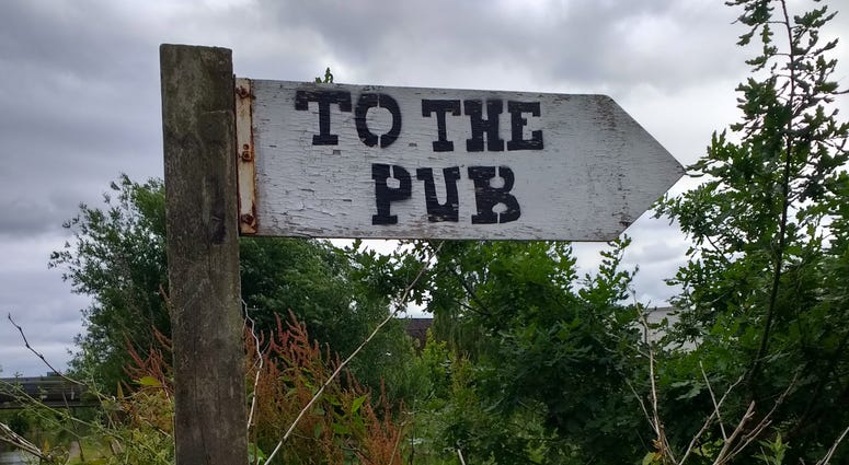 A sign pointing the way to the pub