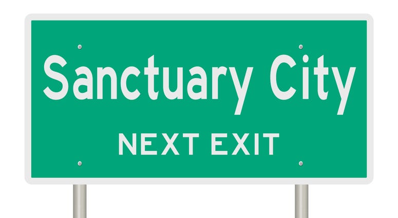 Sanctuary city highway sign