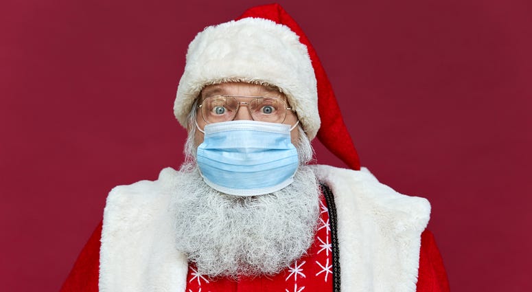 Santa Claus wearing costume, glasses, face mask