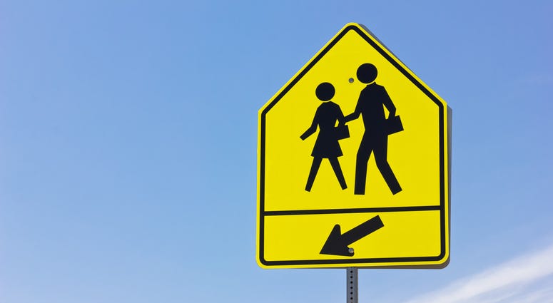 School crosswalk and arrow sign