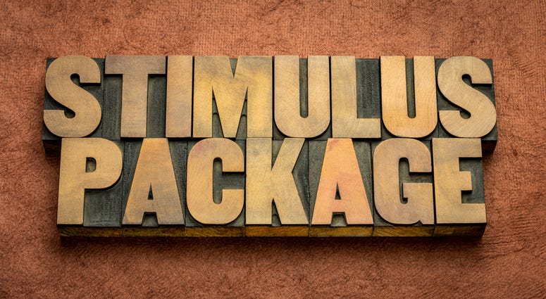 stimulus package word abstract in vintage letterpress wood type against textured handmade paper