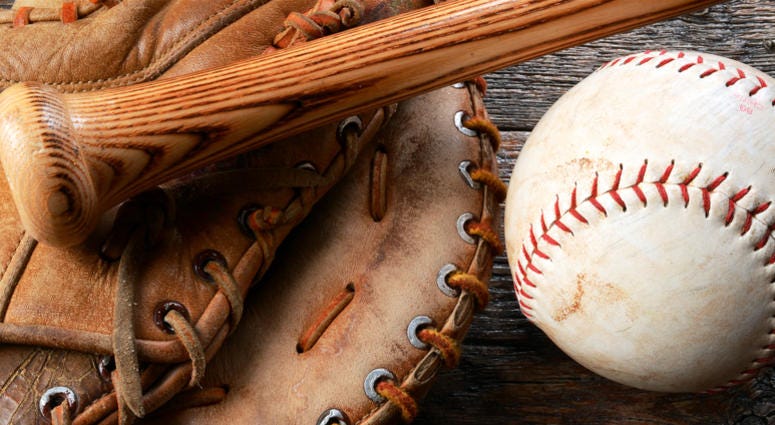 A top view image of an old used baseball, baseball glove, and baseball bat