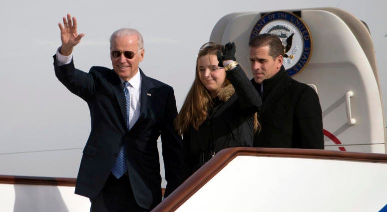 U.S. Vice President Joe Biden waves as he walks out of Air Force Two with his granddaughter Finnegan Biden and son Hunter Biden (R) on December 4, 2013 in Beijing, China.