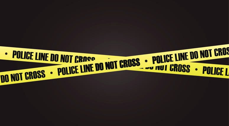 A photo of crime scene tape on a black background.
