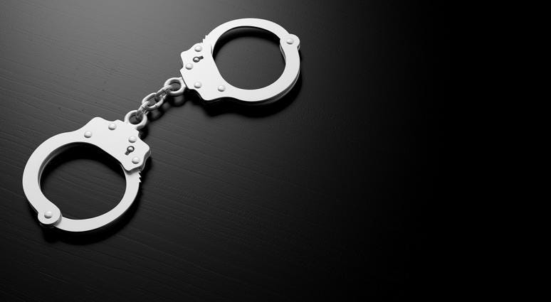 Metal police handcuffs isolated on black background